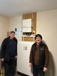 Members of St Ninian Bowling Club - standing beside the newly installed storage battery in the club house.